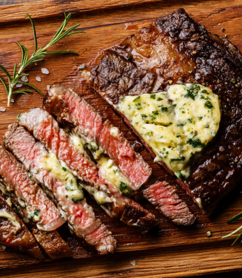 Sliced,Grilled,Medium,Rare,Barbecue,Steak,Ribeye,With,Herb,Butter